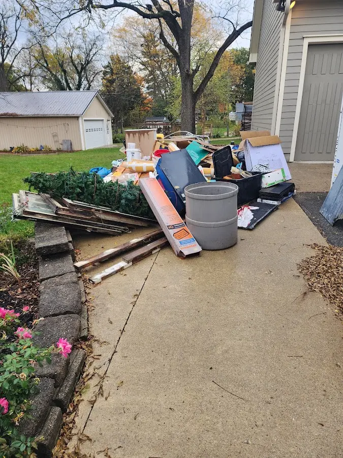 Dumpster being loaded with debris for Estate Cleanout Dumpster Rental in Hubbard